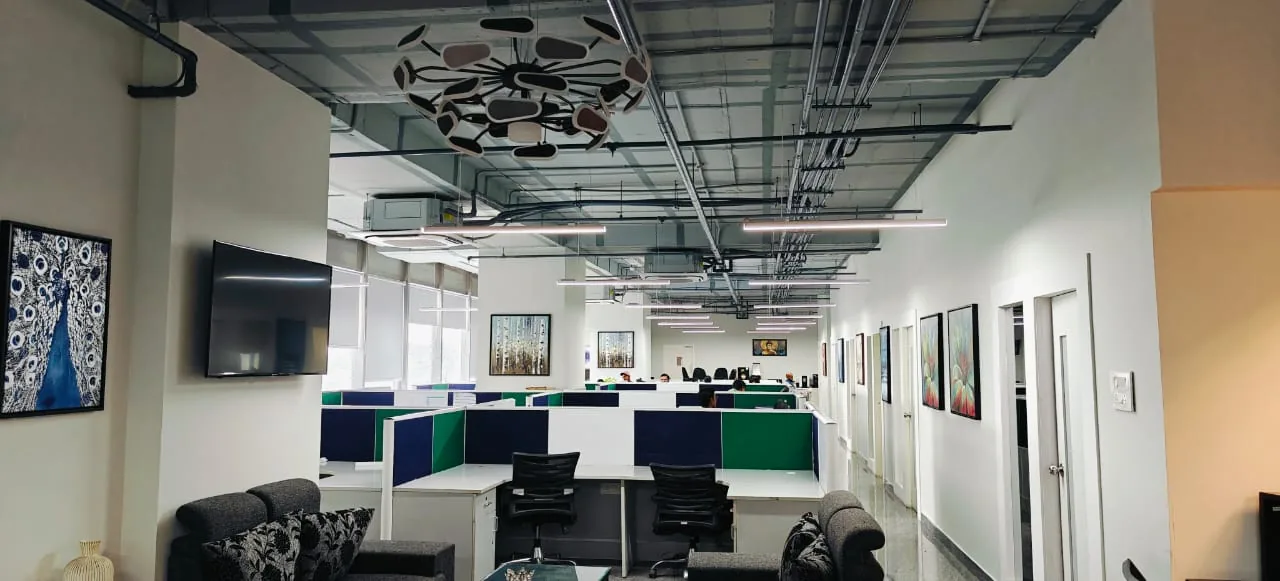 Ameritechsoft office interior with rows of workstations and green accent panels
